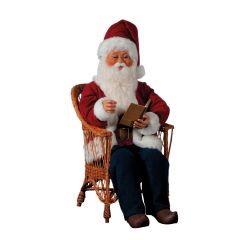 Santa Claus sitting in a chair, reading a book